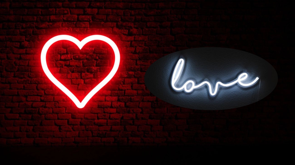 Neon LED sign glowing on dark brick wall